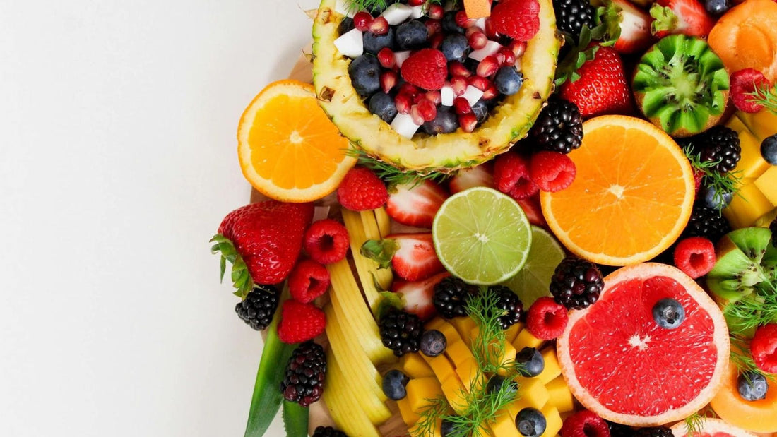 fruit platter of various different fruits on a white surface for making jungle juice