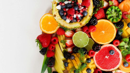 fruit platter of various different fruits on a white surface for making jungle juice