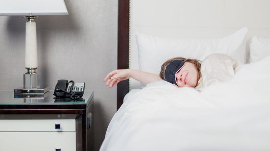 Woman peacefully sleeping with a sleep mask on her face.