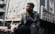 Clichy Bazenga in leather jacket by graffiti truck, Locked-In Energy review, boosted bookings and elevated DJ career